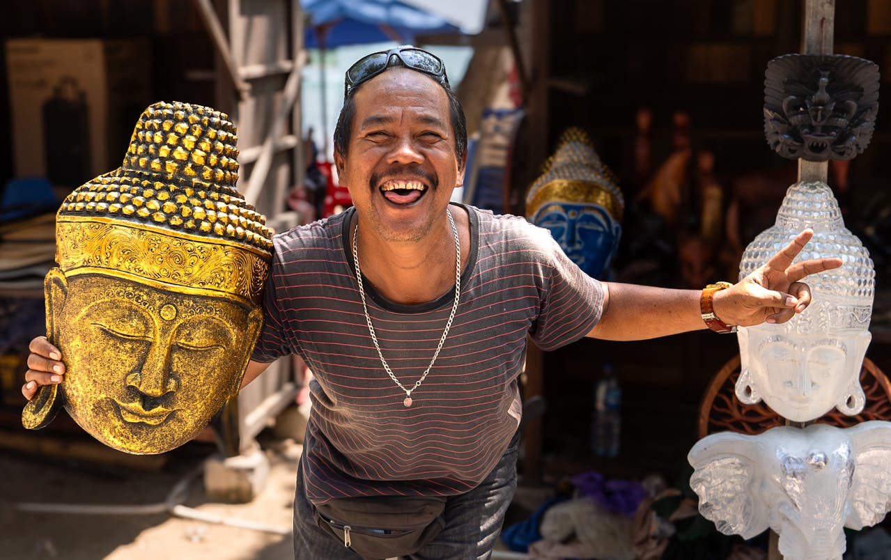 Man shopping in Bali and holding a Buddha sculpture